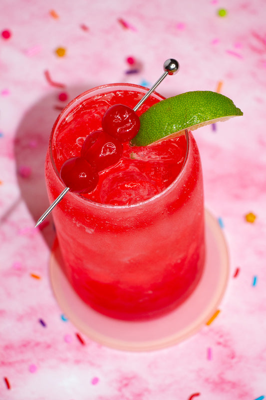 Cherry flavored lemon-lime soda garnished with cherries and a lime wedge.