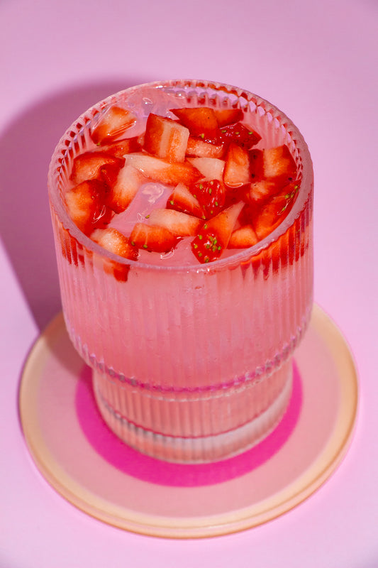 Pink Lemonade drink garnished with diced strawberries