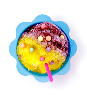 Yellow and Purple Hawaiian Shaved Ice with candy sprinkles